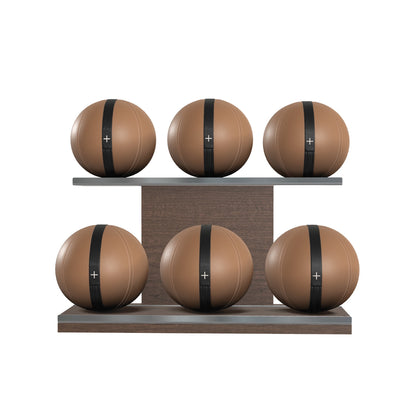 Six brown leather medicine balls with black accent leather, arranged on two shelves made of natural walnut wood. PENT. MOXA Set Ultimate - Set of 6 Medicine Balls on Horizontal Wooden Stand
