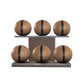 Six brown leather medicine balls with black accent leather, arranged on two shelves made of natural walnut wood. PENT. MOXA Set Ultimate - Set of 6 Medicine Balls on Horizontal Wooden Stand