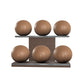 Six brown leather medicine balls with brown accent leather, arranged on two shelves made of natural walnut wood. PENT. MOXA Set Ultimate - Set of 6 Medicine Balls on Horizontal Wooden Stand