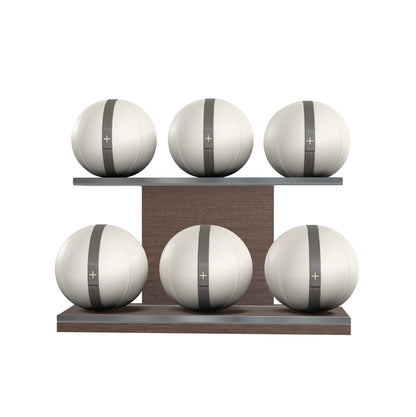 Six white leather medicine balls with grey accent leather, arranged on two shelves made of natural walnut wood. PENT. MOXA Set Ultimate - Set of 6 Medicine Balls on Horizontal Wooden Stand