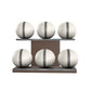 Six white leather medicine balls with grey accent leather, arranged on two shelves made of natural walnut wood. PENT. MOXA Set Ultimate - Set of 6 Medicine Balls on Horizontal Wooden Stand
