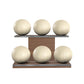 Six beige leather medicine balls with beige accent leather, arranged on two shelves made of natural walnut wood. PENT. MOXA Set Ultimate - Set of 6 Medicine Balls on Horizontal Wooden Stand