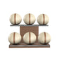 Six beige leather medicine balls with brown accent leather, arranged on two shelves made of natural walnut wood. PENT. MOXA Set Ultimate - Set of 6 Medicine Balls on Horizontal Wooden Stand
