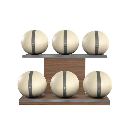 Six beige leather medicine balls with grey accent leather, arranged on two shelves made of natural walnut wood. PENT. MOXA Set Ultimate - Set of 6 Medicine Balls on Horizontal Wooden Stand