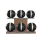 Six black leather medicine balls with white accent leather, arranged on two shelves made of natural walnut wood. PENT. MOXA Set Ultimate - Set of 6 Medicine Balls on Horizontal Wooden Stand