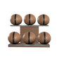 Six brown leather medicine balls with black accent leather, arranged on two shelves made of natural walnut wood. PENT. MOXA Set Ultimate - Set of 6 Medicine Balls on Horizontal Wooden Stand