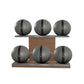 Six grey leather medicine balls with black accent leather, arranged on two shelves made of natural walnut wood. PENT. MOXA Set Ultimate - Set of 6 Medicine Balls on Horizontal Wooden Stand