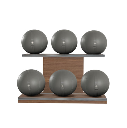 Six grey leather medicine balls with grey accent leather, arranged on two shelves made of natural walnut wood. PENT. MOXA Set Ultimate - Set of 6 Medicine Balls on Horizontal Wooden Stand