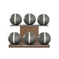Six grey leather medicine balls with white accent leather, arranged on two shelves made of natural walnut wood. PENT. MOXA Set Ultimate - Set of 6 Medicine Balls on Horizontal Wooden Stand