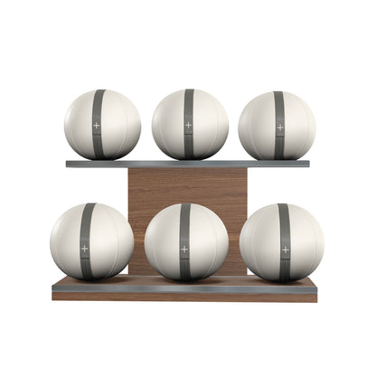 Six white leather medicine balls with grey accent leather, arranged on two shelves made of natural walnut wood. PENT. MOXA Set Ultimate - Set of 6 Medicine Balls on Horizontal Wooden Stand
