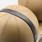 Closeup view of six brown leather medicine balls with black accent leather, arranged on two shelves made of natural walnut wood. PENT. MOXA Set Ultimate - Set of 6 Medicine Balls on Horizontal Wooden Stand