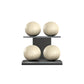 Four beige leather medicine balls with beige accent leather, arranged on two shelves made of black ash wood. PENT. MOXA Power - Set of 4 Medicine Balls on Horizontal Wooden Stand