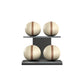 Four beige leather medicine balls with brown accent leather, arranged on two shelves made of black ash wood. PENT. MOXA Power - Set of 4 Medicine Balls on Horizontal Wooden Stand