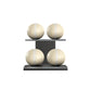 Four beige leather medicine balls with white accent leather, arranged on two shelves made of black ash wood. PENT. MOXA Power - Set of 4 Medicine Balls on Horizontal Wooden Stand