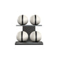 Four white leather medicine balls with black accent leather, arranged on two shelves made of black ash wood. PENT. MOXA Power - Set of 4 Medicine Balls on Horizontal Wooden Stand