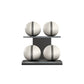 Four white leather medicine balls with grey accent leather, arranged on two shelves made of black ash wood. PENT. MOXA Power - Set of 4 Medicine Balls on Horizontal Wooden Stand