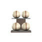 Four beige leather medicine balls with brown accent leather, arranged on two shelves made of natural walnut wood. PENT. MOXA Power - Set of 4 Medicine Balls on Horizontal Wooden Stand