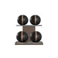 Four black leather medicine balls with brown accent leather, arranged on two shelves made of natural wood. PENT. MOXA Power - Set of 4 Medicine Balls on Horizontal Wooden Stand
