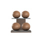 Four brown leather medicine balls with brown accent leather, arranged on two shelves made of natural wood. PENT. MOXA Power - Set of 4 Medicine Balls on Horizontal Wooden Stand