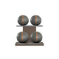 Four grey leather medicine balls with brown accent leather, arranged on two shelves made of natural wood. PENT. MOXA Power - Set of 4 Medicine Balls on Horizontal Wooden Stand