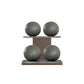 Four grey leather medicine balls with grey accent leather, arranged on two shelves made of natural wood. PENT. MOXA Power - Set of 4 Medicine Balls on Horizontal Wooden Stand