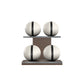 Four white leather medicine balls with black accent leather, arranged on two shelves made of natural walnut wood. PENT. MOXA Power - Set of 4 Medicine Balls on Horizontal Wooden Stand