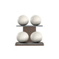 Four white leather medicine balls with white accent leather, arranged on two shelves made of natural walnut wood. PENT. MOXA Power - Set of 4 Medicine Balls on Horizontal Wooden Stand