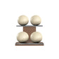Four beige leather medicine balls with beige accent leather, arranged on two shelves made of natural walnut wood. PENT. MOXA Power - Set of 4 Medicine Balls on Horizontal Wooden Stand