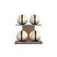 Four beige leather medicine balls with black accent leather, arranged on two shelves made of natural walnut wood. PENT. MOXA Power - Set of 4 Medicine Balls on Horizontal Wooden Stand