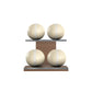 Four beige leather medicine balls with white accent leather, arranged on two shelves made of natural walnut wood. PENT. MOXA Power - Set of 4 Medicine Balls on Horizontal Wooden Stand