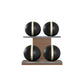 Four black leather medicine balls with beige accent leather, arranged on two shelves made of natural walnut wood. PENT. MOXA Power - Set of 4 Medicine Balls on Horizontal Wooden Stand