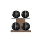 Four black leather medicine balls with grey accent leather, arranged on two shelves made of natural walnut wood. PENT. MOXA Power - Set of 4 Medicine Balls on Horizontal Wooden Stand