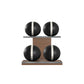 Four black leather medicine balls with white accent leather, arranged on two shelves made of natural walnut wood. PENT. MOXA Power - Set of 4 Medicine Balls on Horizontal Wooden Stand