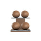 Four brown leather medicine balls with brown accent leather, arranged on two shelves made of natural walnut wood. PENT. MOXA Power - Set of 4 Medicine Balls on Horizontal Wooden Stand