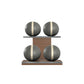 Four grey leather medicine balls with beige accent leather, arranged on two shelves made of natural walnut wood. PENT. MOXA Power - Set of 4 Medicine Balls on Horizontal Wooden Stand