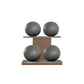 Four grey leather medicine balls with grey accent leather, arranged on two shelves made of natural walnut wood. PENT. MOXA Power - Set of 4 Medicine Balls on Horizontal Wooden Stand