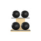 Four black leather medicine balls with black accent leather, arranged on two shelves made of natural ash wood. PENT. MOXA Power - Set of 4 Medicine Balls on Horizontal Wooden Stand