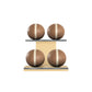 Four brown leather medicine balls with beige accent leather, arranged on two shelves made of natural ash wood. PENT. MOXA Power - Set of 4 Medicine Balls on Horizontal Wooden Stand