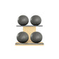 Four grey leather medicine balls with grey accent leather, arranged on two shelves made of natural ash wood. PENT. MOXA Power - Set of 4 Medicine Balls on Horizontal Wooden Stand