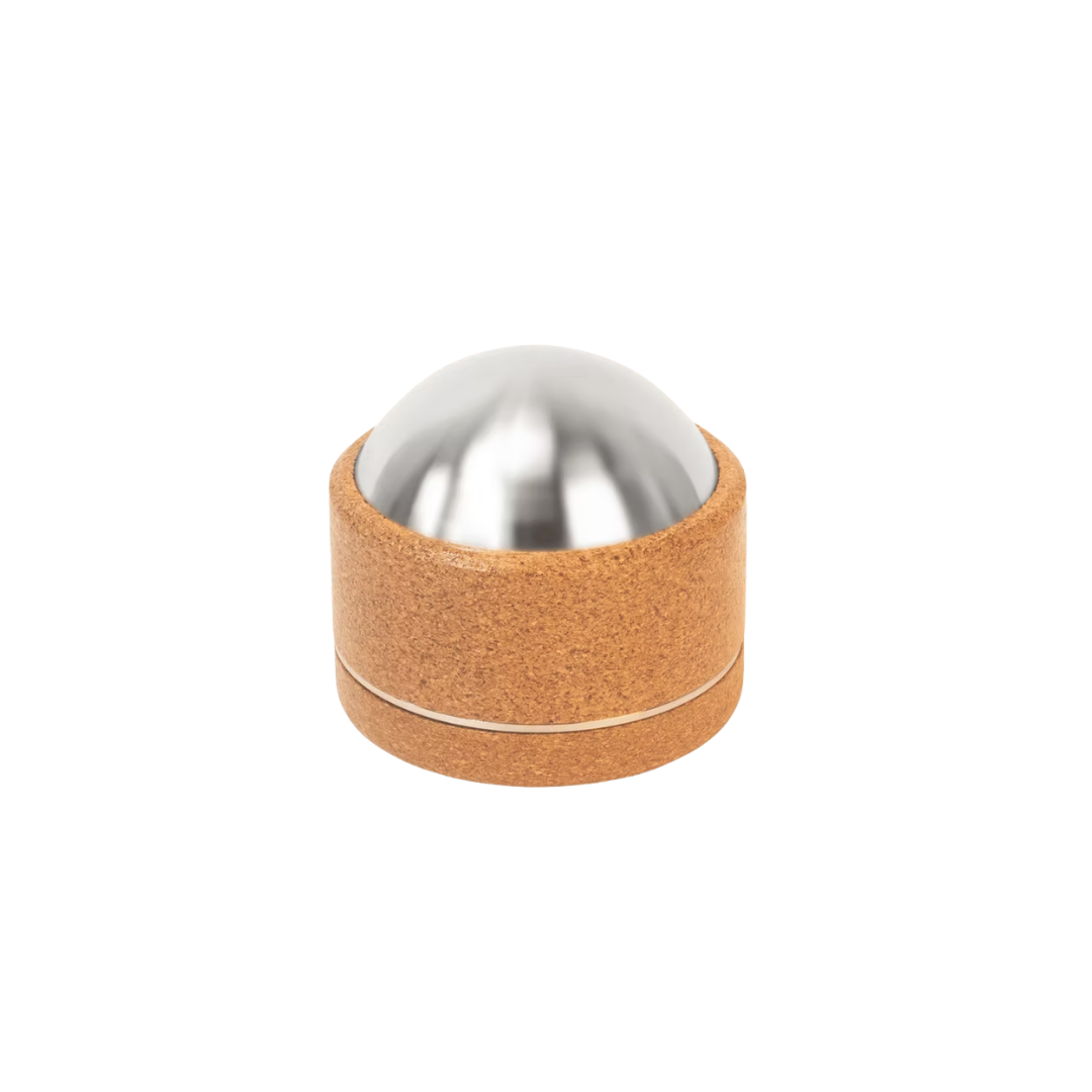Kenko Massage Ball with stainless steel core and cork exterior isolated on white.