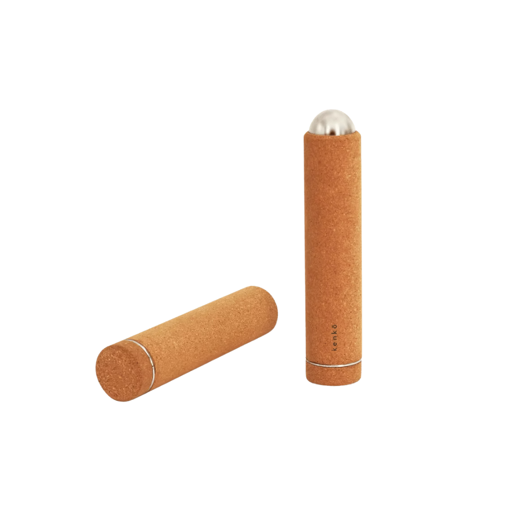 Kenko Massage Stick with cork exterior and stainless steel core on white background.
