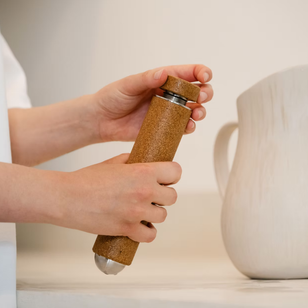 Person holding the kenko massage tool filled with water.