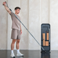 Person using the NOHRD StepTower for a full-body workout in a modern home gym.