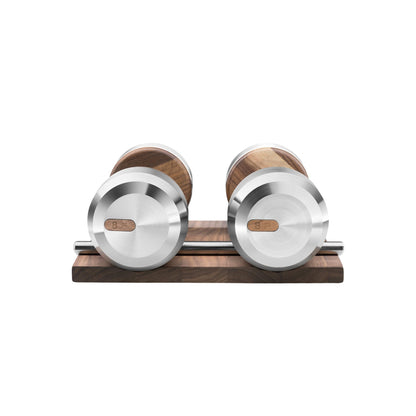 Front view of the luxury dumbbells made with natural walnut wood and stainless steel on natural walnut wooden stand. Available in weights ranging between 2 - 30kg. PENT. COLMIA - Luxury Dumbbells on Wooden Stand