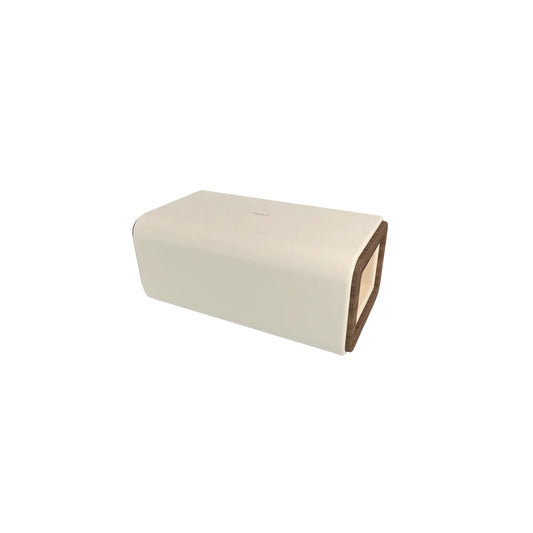 A luxurious reformer box with a white leather exterior and a wooden base.