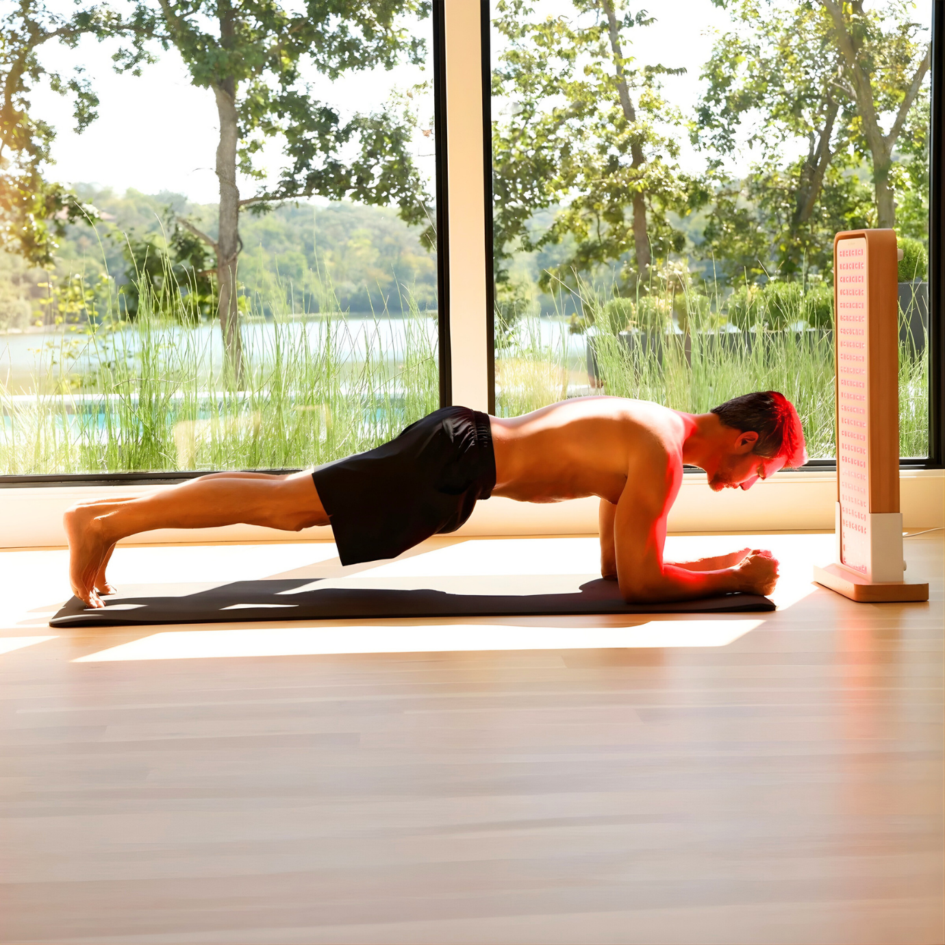 Person using Sunlighten Red Light Therapy Panel during a recovery session at home.