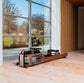 A luxury fitness equipment, walnut wooden water rowing machine placed in luxury home gym, for full-body workout with the soothing sounds of water. Stil-Fit Flow One - Rowing Machine with water resistance