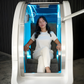 Person experiencing mild hyperbaric oxygen therapy inside AirPod wellness pod.