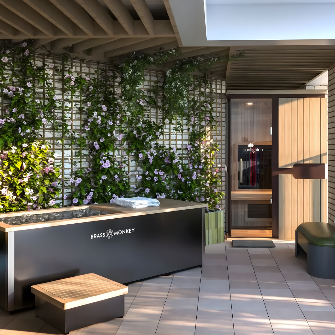 Luxury wellness suite featuring Sunlighten infrared sauna and Brass Monkey ice bath for contrast therapy.