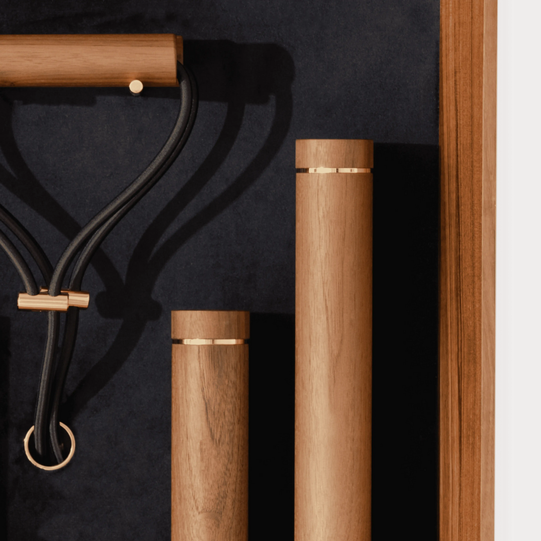 Close-up of walnut wood wall set with stainless steel and brass hardware detail.